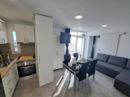 a kitchen and living room with a couch and a table at Panoramic Floor - Las Americas in Playa de las Americas