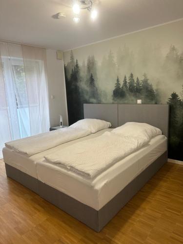 a bedroom with two beds and a painting on the wall at Ferienwohungen Akwant in Baden-Baden