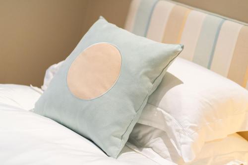 a pillow sitting on top of a bed at Strathallan - Luxury 3 Bedroom Apartment, Gleneagles, Auchterarder in Auchterarder