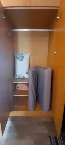 a small closet with a bed and a pillow at Cameron Square in Brinchang