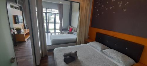 a bedroom with a bed and a large mirror at aparthotel cameron in Brinchang