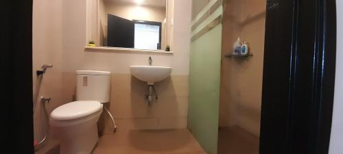 a bathroom with a white toilet and a sink at Cameron Square in Brinchang