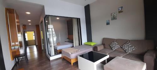 a living room with a couch and a large mirror at Cameron Square in Brinchang