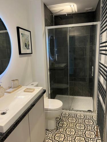 a bathroom with a shower and a toilet and a sink at Luxury garden apartment under the Castle, Dover in Dover