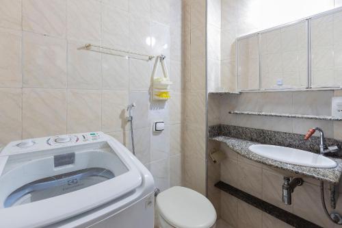 a small bathroom with a toilet and a sink at Copacabana Beachside Retreat in Rio de Janeiro