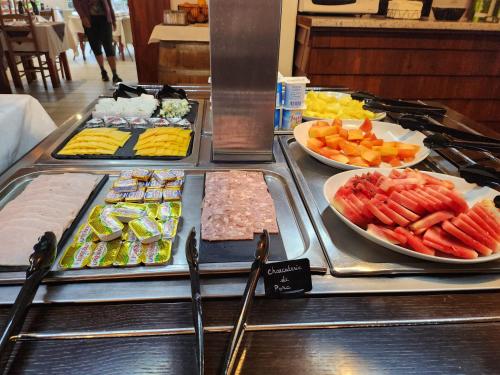 a buffet with many different types of food on display at Hotel Des Neiges in Cilaos