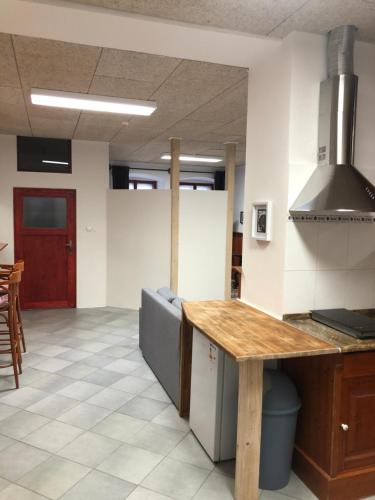 a kitchen with a wooden counter top in a room at Apartman U Andela in Vodňany