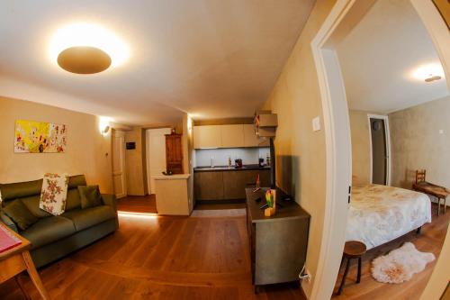 a living room with a couch and a bed and a kitchen at La Noix - Alloggi ad uso turistico - VDA - ARVIER - n 0041 e n 0042 in Arvier