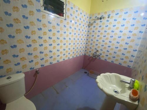 a bathroom with a toilet and a sink at Mahavatar Babaji Farm Stay in Bangalore