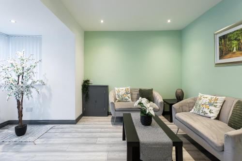 a living room with two couches and a coffee table at Fully Refurbished North Belfast Home 2 in Belfast