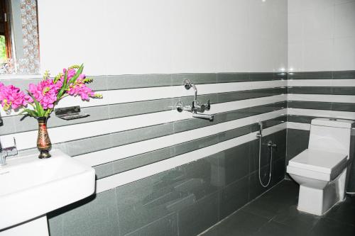 a bathroom with black and white stripes on the wall at River Stay - Homestay by Wanderlust Rural Tourism in Dehradun