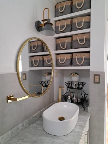 a bathroom with a white sink and a mirror at Casa Ramos Salamanca - Airport pick up and drop off service - Homestay in Lima