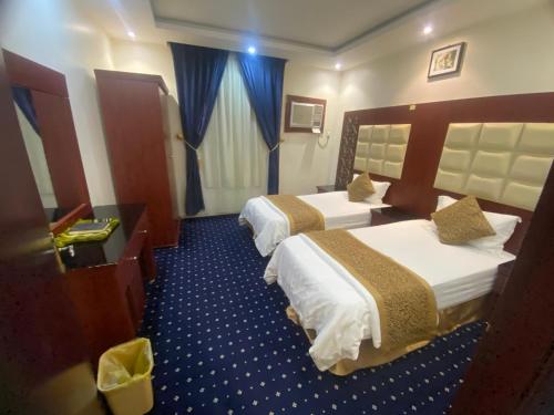 Un ou plusieurs lits dans un hébergement de l'établissement فندق أسس التاج