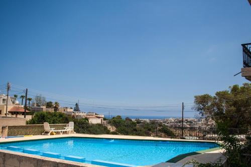 a swimming pool with a view of the ocean at Spacious modernist Apt with views & pool in Tal-Mejda