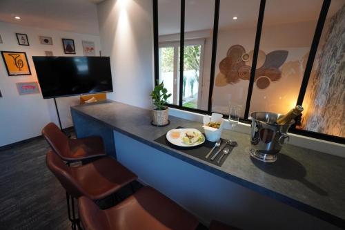 a bar with a plate of food on a counter at The Green Garden Spa & Serenity in Mittelhausbergen