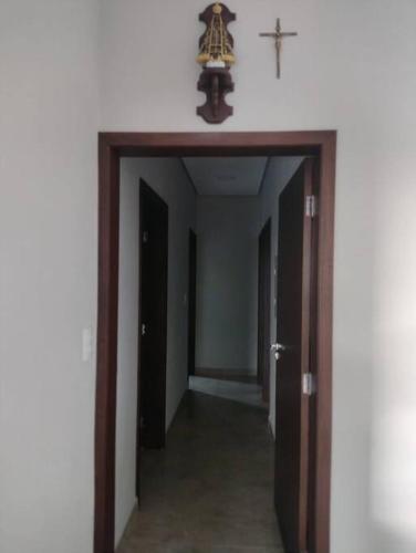 a hallway with a cross on the wall and a cross on the ceiling at Rancho Pôr do Sol in Piumhi