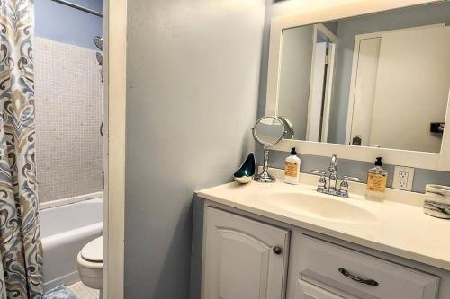 a bathroom with a sink and a mirror at Perfect Couples Retreat - close to all amenities in Hot Springs