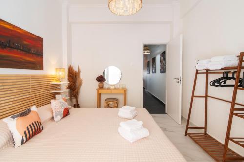 a bedroom with a bed with white towels on it at Spa Diamond, 71 sqm, private Whirlpool in Athens