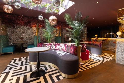 a lobby with a couch and a table at The Tempus at Charlton Hall Estate in Alnwick