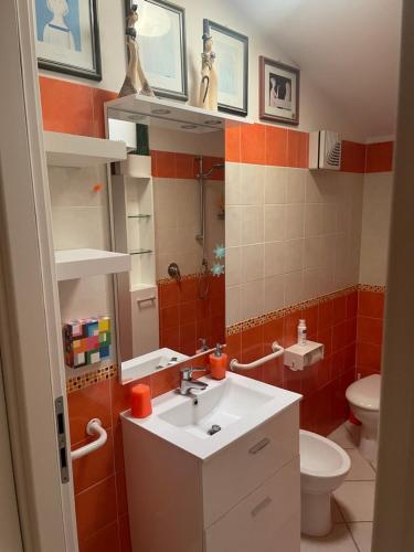 a bathroom with a sink and a toilet at Mare Fuori in Marina di Grosseto