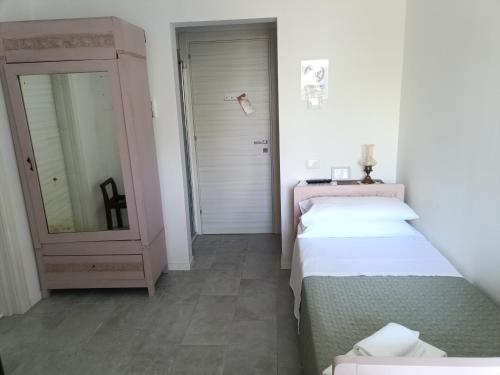 a small room with two beds and a mirror at b&b RetrO'Conero in Castelfidardo