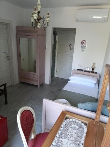 a living room with two beds and a couch at b&b RetrO'Conero in Castelfidardo