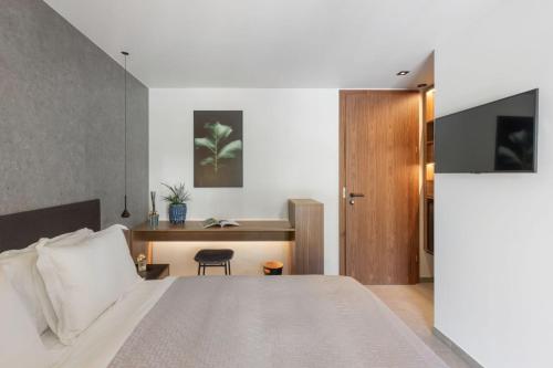 a bedroom with a large bed and a desk at 3 VIE Restaurant & Rooms in Acquarossa