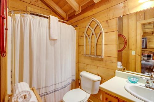a bathroom with a white shower curtain and a toilet at Little Fox Den Ellijay Cabin Rental with Hot Tub! in Ellijay