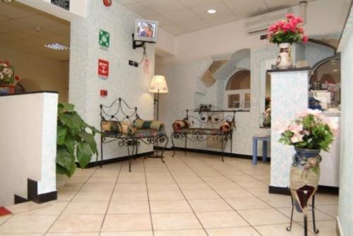 a large room with flowers on display in a pharmacy at Hotel Acquario in Genova