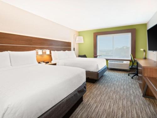a hotel room with two beds and a desk at Holiday Inn Express & Suites Niceville - Eglin Area by IHG in Niceville