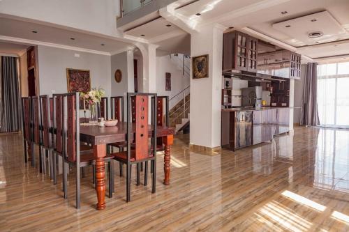 a kitchen and dining room with a table and chairs at Villa Mater Dolorosa in Gitega