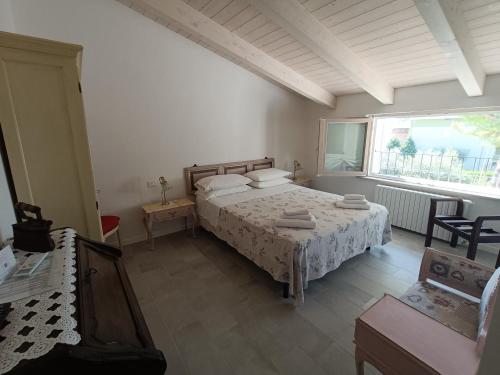 a bedroom with a bed and a large window at b&b RetrO'Conero in Castelfidardo