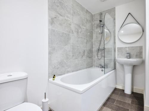 a bathroom with a tub and a sink and a toilet at 1885 the Venue - Pub, Restaurant, Rooms & Function House in Halifax