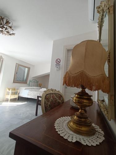 a lamp sitting on a wooden table in a bedroom at b&b RetrO'Conero in Castelfidardo