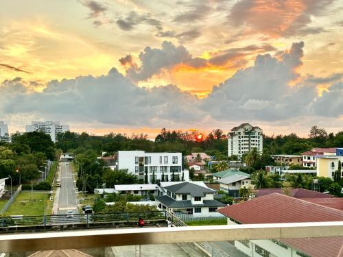 a cityscape of a city with a sunset at Deco Home @ Aru Suites in Kota Kinabalu