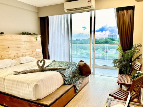 a bedroom with a bed and a large window at Deco Home @ Aru Suites in Kota Kinabalu