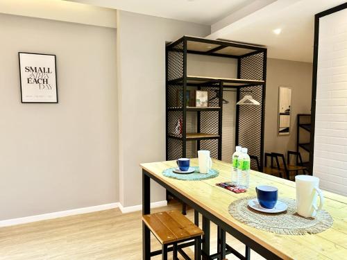 a dining room with a wooden table and chairs at Deco Home @ Aru Suites in Kota Kinabalu