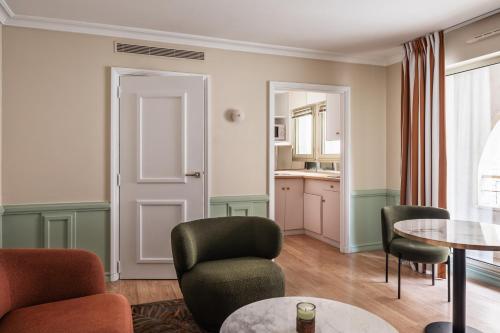 a living room with chairs and a table at Royal Garden Champs-Élysées in Paris