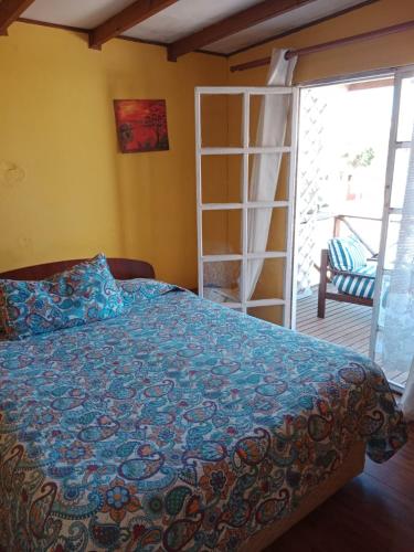 a bedroom with a bed and a door to a patio at Cabaña playa in Coquimbo