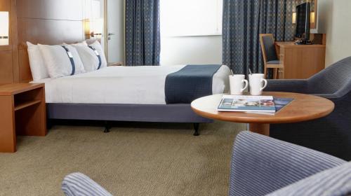 a hotel room with a bed and a table and chairs at Holiday Inn Hull Marina, an IHG Hotel in Hull