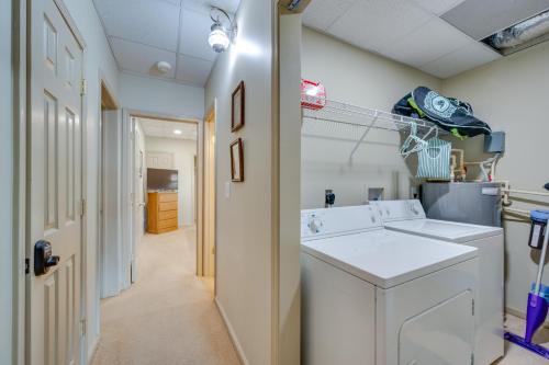 a laundry room with a washer and dryer at Luxe Lake Sinclair Living Private Dock and Beach! in Resseaus Crossroads