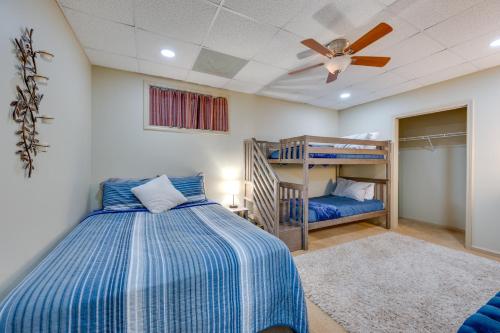 a bedroom with two bunk beds and a ceiling fan at Luxe Lake Sinclair Living Private Dock and Beach! in Resseaus Crossroads