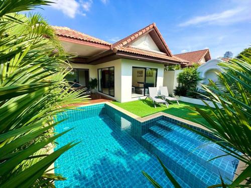 a swimming pool in front of a house at View Talay Villas - Luxury, 1 Bedroom - private pool villa, 500m from Jomtien beach - VTV 171 in Jomtien Beach