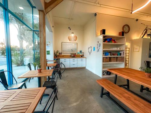 a restaurant with tables and chairs and a large window at ITH Santa Barbara Beach Hostel in Santa Barbara