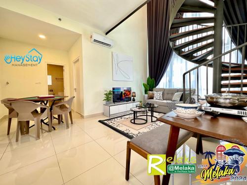 a living room with a table and a dining room at The Apple Residence By Heystay Management in Melaka