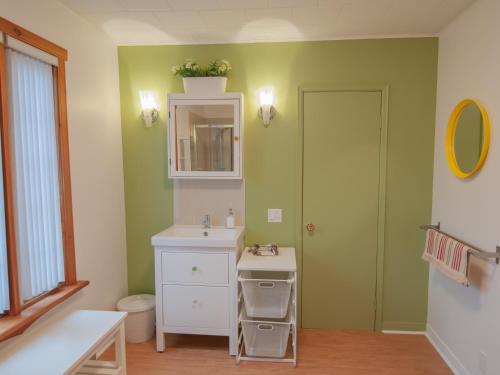 a bathroom with a sink and a mirror at La Maison Gagnon in Saguenay