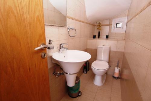 a bathroom with a sink and a toilet at Maouris Villa in Protaras