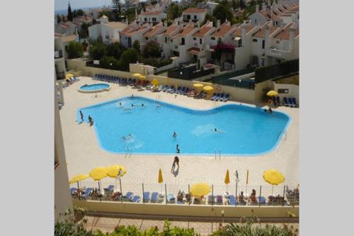 a large swimming pool with people swimming in it at Apartamento Ariadna in Albufeira