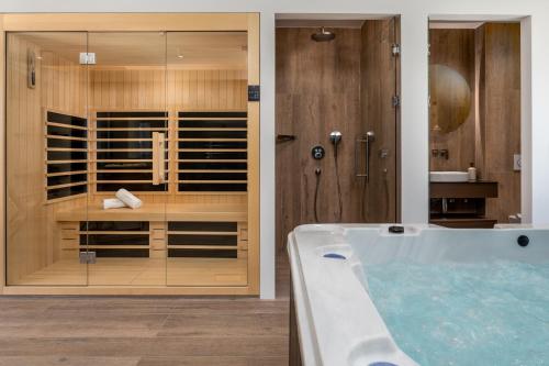 a bathroom with a tub and a walk in shower at Luxury Villa La Mirada in Omiš