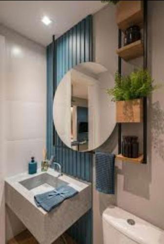 a bathroom with a sink and a mirror at Casa in Sorocaba